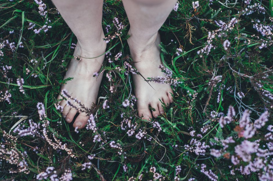The bare feet of a child in the grass