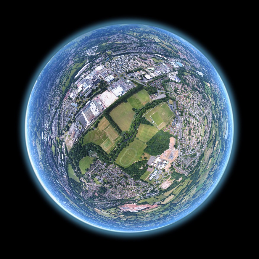 Aerial fisheye of a suburban landscape superimposed on planet earth. Image by Louis Reed @ Unsplash.